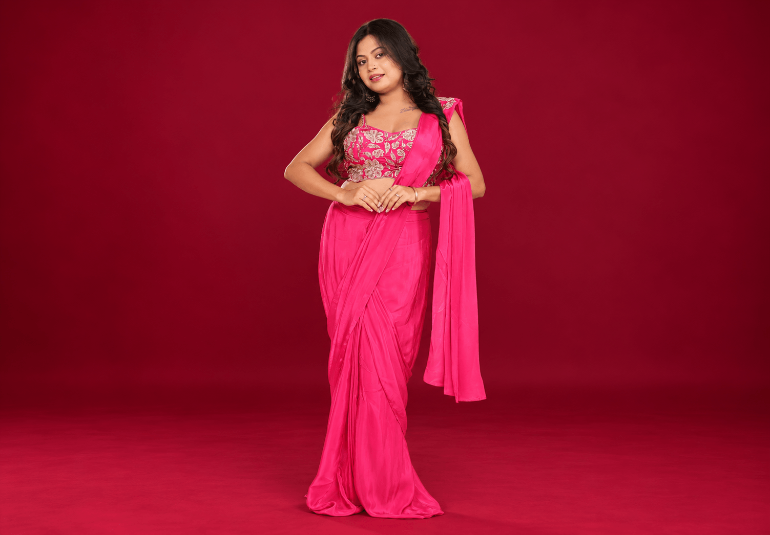 fuchsia saree against burgundy backdrop